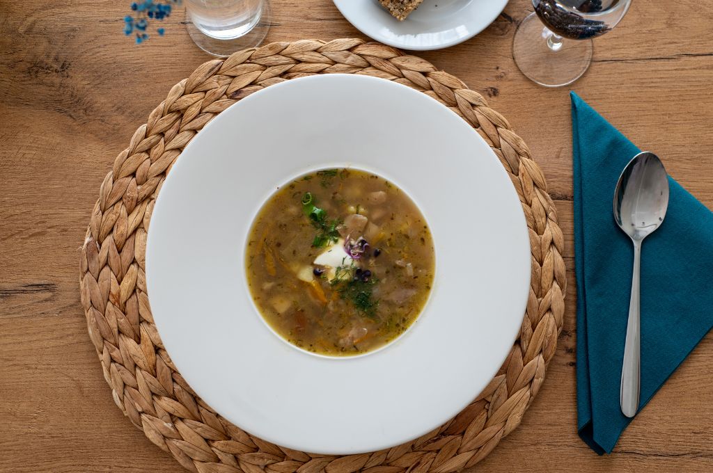 Romantic dinner setting at Amicus Hotel Vilnius with dish and wine, Vilnius Hotels